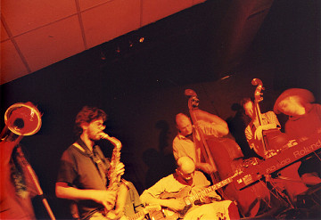 Philémon, Sam Shalabi, Nicolas Caloia, Alexandre St-Onge, and Jesse Levine (and on theleft side the trombone of Jacques Gravel) live at Le Va-et-vient [Photo: James Schidlowsky, Montréal (Québec), March 26, 2003]